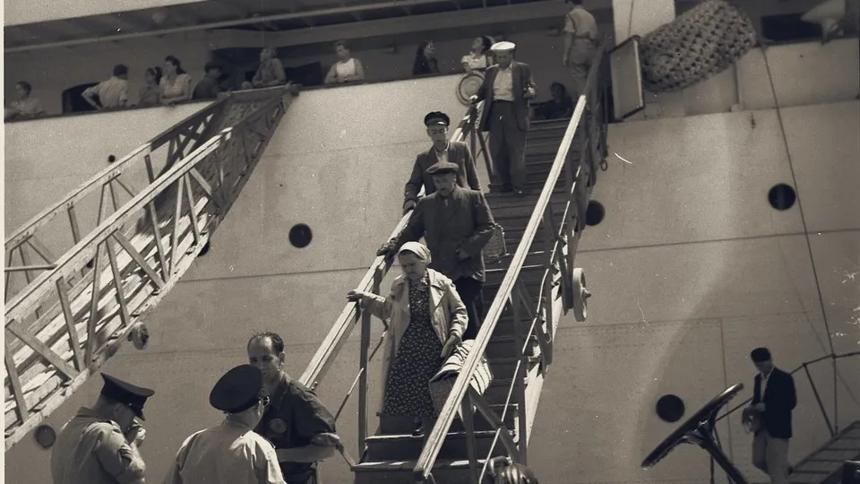 New immigrants from Romania come down a ship's gangway at Haifa port, June 1951.