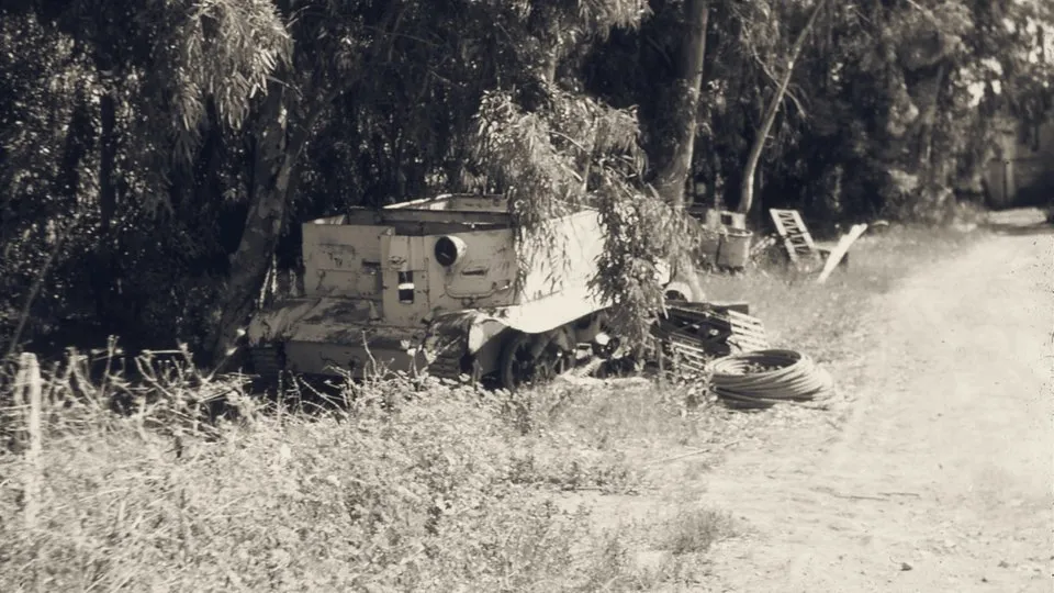 A stopped tracked armoured carrier under the eucalyptus trees at Degania Alef; the archive's catalogue dates the slide to 20 May 1948.