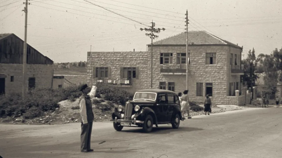 One of Israel's first policemen directs traffic on Ussishkin Street, Jerusalem, June 1948.