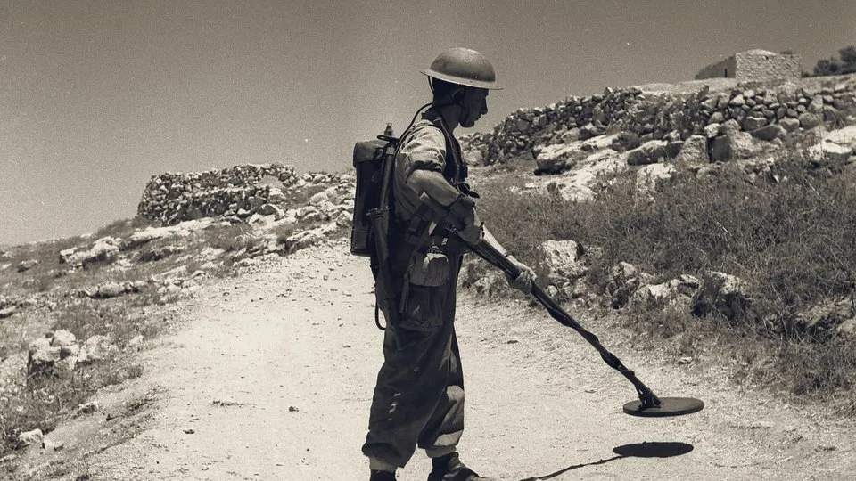 A soldier sweeps a Galilee road for mines after Operation Hiram, 1948.