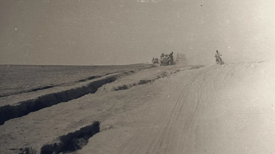 A column of IDF vehicles and a motorcyclist on a desert track in the Negev during Operation Horev, December 1948.